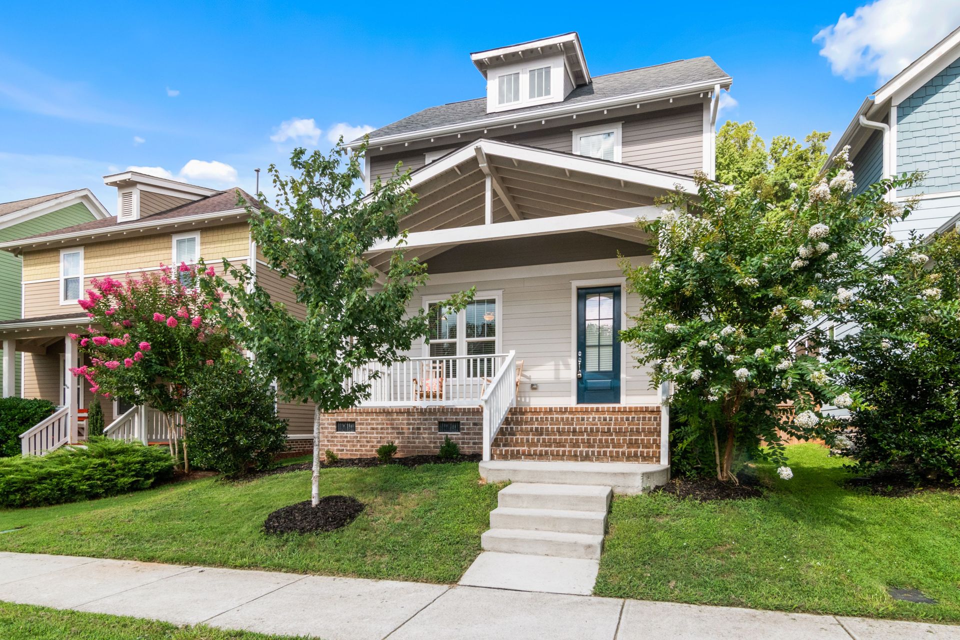 Beautiful suburban home with a landscaped yard and welcoming porch.